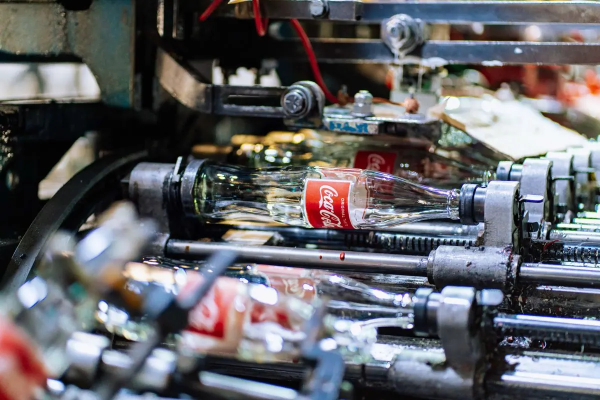 Blows preforms into finished PET bottles for beverages and household liquids.