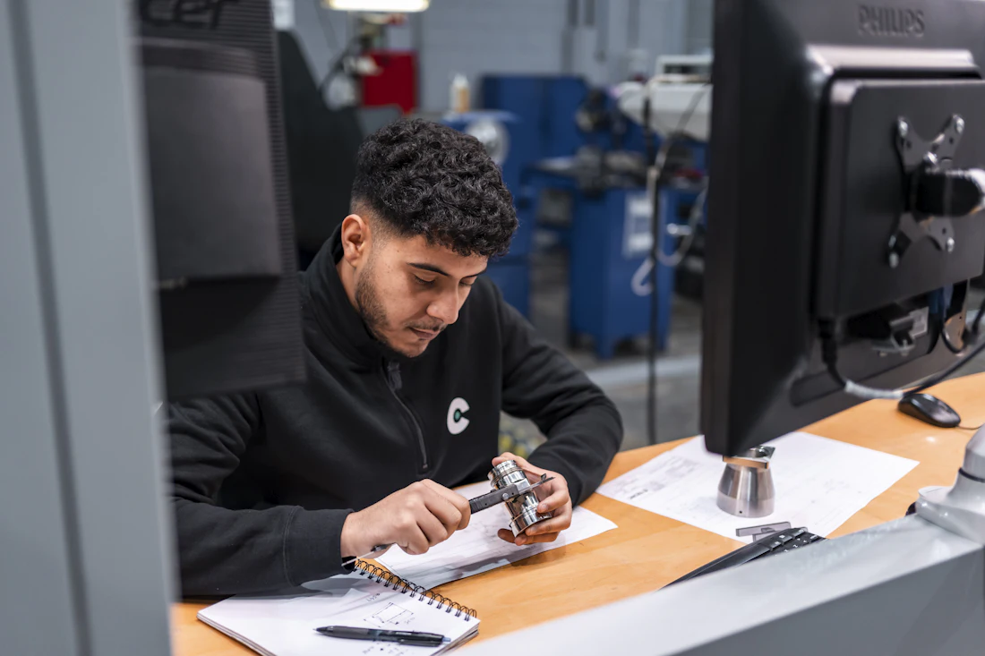 Inspector checking goods against a specification sheet before shipment